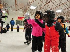 Families gathered at the Glengarry Arena (13340 85 St) as she takes part in a learn-to-skate program for new families last weekend. The program is a joint effort between the Fliteway Figure Skating Club and the Edmonton Mennonite Centre for Newcomers. TREVOR ROBB Edmonton Examiner