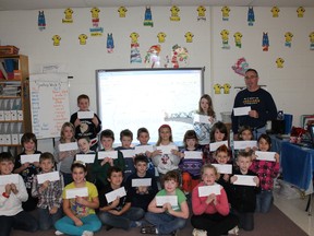 Students in Chris Shannon's Grade 3/4 class at St. Joseph Catholic School show off the letters they have written to soldiers stationed in Kabul, Afghanistan. The idea came from Michaela Watters' father, Sgt. Timothy Watters, who is also stationed there this Christmas.