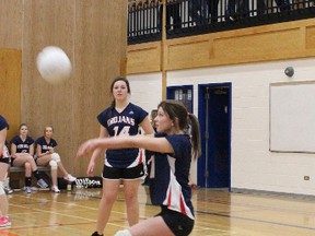 Brynn Glover keeps the ball in play during the junior girls volleyball game last Wednesday against Rideau, while teammate Rachel Dorey watches. The Trojans lost all three sets to Rideau, 19-25, 23-25 and 18-25.