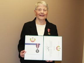 Anita Côté displays her Diamond Jubilee Medal and her certificate signed by the Governor General that she received in Timmins Friday night.