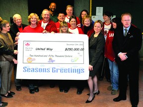 Procter and Gamble Brockville staff help United Way of Leeds and Grenville executive director Judi Baril, second from left, and United Way president an CEO Dr. Jacline Abray-Nyman support a hefty cheque for $250,000 on Thursday. (DARCY CHEEK/The Recorder and Times)