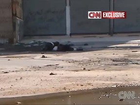 A 17-year-old Syrian boy crawls on the street as he tries to save a sniper victim. (CNN)