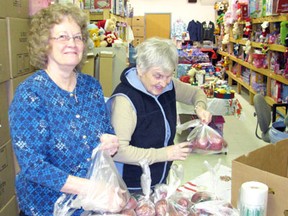 Kenora Salvation Army volunteers Darlene Fish and June Lund are busy loading potatoes and other food items into hamper boxes to help make a joyful Christmas season for a local family in need. The church expects to distribute up to 350 hampers this Christmas beginning Tuesday, Dec. 18.