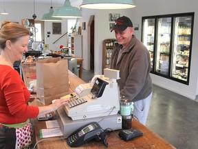 Limestone Creamery employee Sue Hall serves customer Paul Scriver. (Michael Lea/The Whig-Standard)