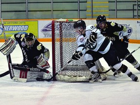 Ryan Kruper tries to stuff one by Pontiacs netminder Tyler Santos as a Bonnyville defender loses his stick trying to stop him. Trent Wilkie/Sherwood Park News/QMI Agency
