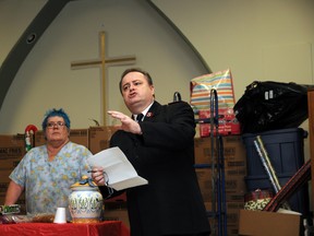 Salvation Army head chef Linda Cowell (left) listens in as Major Daniel Roode describes  how increased funding of $2.4 million from the provincial government to Grande Prairie will help the city’s homeless population. (Patrick Callan/Daily Herald-Tribune)