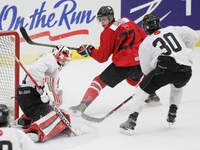 Team Canada hopeful Phillip Danault looks back at Owen Sound Attack goaltender Jordan Binnington makes a save during a game Thursday afternoon between players vying for spots on the national junior team in this file photo. Binnington stopped 30 shots in an exhibition win against Sweden in Helsinki, Finland on Saturday.