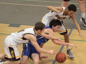 Steelhawks’ Sean McGonigal (middle) battles for the loose ball with Korah’s Anthony Iacoe (left) and Sam Ivey (right).