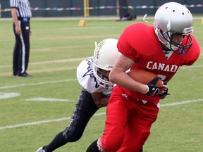 Woodstock's John Tryhub breaks free from a tackle at the International Friendly Bowl that was part of the 2012 Pop Warner Super Bowl. Team Canada went on to win the gold medal after winning all three of their games.