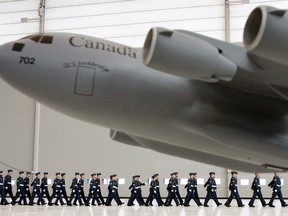 Current members of 429 Transport Squadron at 8 Wing/CFB Trenton, Ont. take part to a trooping the colour ceremony to celebrate the squadron's 70th anniversary at the air base Wednesday, Nov. 7, 2012. The squadron first formed in England in 1942 and was reformed in 2007 in order to begin operating the four C-17 Globemasters based in Trenton, Ont. (see replica above). Jerome Lessard/The Intelligencer/QMI Agency