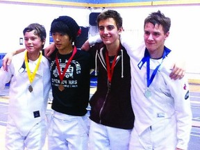 David Eliot of Cutting Edge Fencing in Kingston poses with teammate Anthony Guolla and fellow competitors at the Ottawa Junior Fencing Championships in Ottawa on December 1st. Eliot won the silver medal in the Large Cadet Men's Epee while Guolla took the bronze in the same event. Many Cutting Edge fencers fared well at the competition.    Contributed photo - Marcia McDonald