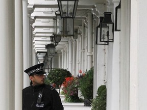 A police officer stands guard in front of the home of Eva Rausing in London on July 11, 2012. (REUTERS/Olivia Harris)