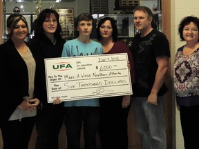 Nathan Hardy, (holding cheque) Devon’s entrant into last summer’s United Farmers of Alberta (UFA) Hometown Heroes contest, along with UFA representative Lisa Dunn, hands off the $6,000 he earned as a finalist to Zahita Hudani (far left) from the Northern Alberta Make-A-Wish office, at John Maland High School on Friday, Dec. 7. 
Hardy was also accompanied by parents Susan and Dave, and by local Make-A-Wish volunteer Laurie Keindel (right). Keindel worked with Hardy on granting his own wish, and was glad to see the way that Hardy has now given back to the organization that gave to him.
“When a wish turns into a ‘circle of life’ story, it feels like all the healing, physically, mentally, socially, and spiritually has occurred, and it becomes a beautiful thing,” said Keindel.