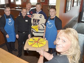 Wetaskiwin-Camrose Catholic Social Services' Sign of Hope campaign co-ordinator Sheila Cole holds up a Boston Pizza box with paper slices of pizza, which could be purchased throughout the day at the Wetaskiwin location. Looking on are: Wetaskiwin Mayor Bill Elliot, Boston Pizza owner and Wetaskiwin-Camrose Sign of Hope campaign chairman Dave Dowler, Wetaskiwin Icemen director Glen Rogers, Wetaskiwin Icemen president Rob Dyck, and Edmonton Sun publisher and Sign of Hope campaign chairman John Caputo.