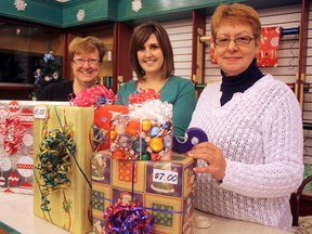 Volunteers from the Timmins Seizure and Brain Injury Centre (SBIC), from left, Laurie Lindsay, Kate McLaren and Rejeanne James, are among the merry elves patrolling the gift-wrapping centre at Timmins Square from now until Christmas Eve. The SBIC is splitting present-wrapping duties with Les Perles du Nord of the Club Richelieu, and the Canadian Cancer Society, the latter of which will be taking over the shop starting Dec. 17.