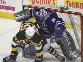 Mississauga Steelheads goalie Tyson Teichmann gets a face full of the Kingston Frontenacs' Jean Dupuy during first-period action in Friday night's OHL game at the K-Rock Centre. The Frontenacs went on to win the game 2-1 in a shootout.