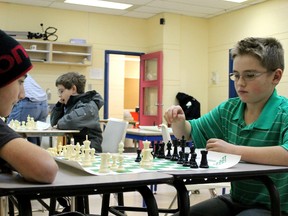 Johnny Burn and Benjamin Farrington, both 11, play a game of chess at the Fort McMurray Chess Club at the YMCA last year.