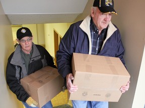 Boyd Fraser and Jim Degurse help deliver food hampers in Corunna for Operation Christmas Tree. (Observer file photo)