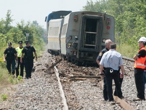 OPP and CN Rail Police survey the damage after a VIA Rail train derailed near Glencoe on Friday July 29th, 2011. The 116 passengers on the train were heading from Oshawa to Windsor when it collided with a pickup truck at a level crossing on Pratt Siding Road. CRAIG GLOVER The London Free Press / QMI AGENCY