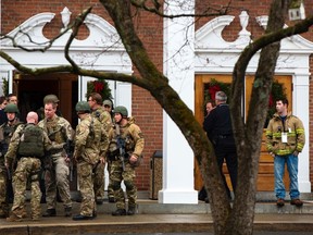 Members of a Connecticut State Police SWAT team depart the St. Rose of Lima Catholic church in Newtown, Connecticut December 16, 2012.  REUTERS/Lucas Jackson