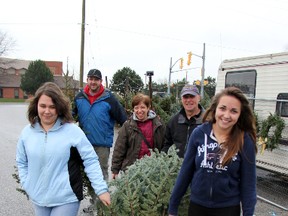 The Hihn family of Sarnia — Victoria and Maddy (front) along with parents John and Cathy — picked out their Christmas tree over the weekend, with the help of Matt Churchill (back) of Three Seasons Lawn Care, at the company's Exmouth Street tree lot. TARA JEFFREY/THE OBSERVER/QMI AGENCY
