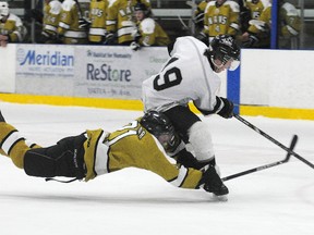 TERRY FARRELL/DAILY HERALD-TRIBUNE/QMI AGENCY
Navigators defenceman Hunter Millar dives to pokecheck Kings forward Ryan Trudeau. The Grande Prairie Kings defeated the North Peace Navigators 8-7 in a shootout in North West Hockey League play at the Coca-Cola Centre in Grande Prairie, Alberta, Saturday, Dec. 15, 2012.