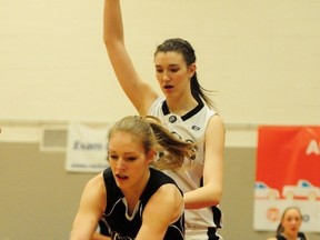 Harry Ainlay Titans forward Mackenzie Cooke reaches for a loose ball during the first quarter of the senior girl's final against the South Kamloops Titans at the 31st annual Go Auto REB Invitational Basketball Tournament at Jasper Place high School in Edmonton, AB, on Saturday, Dec. 15, 2012. TREVOR ROBB/QMI AGENCY