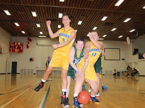 The MUCC Comets' Kyla Hankins is boxed in by two Humboldt Mohawks during the Comets' 31-28 loss to the Mohawks on Friday, December 14.