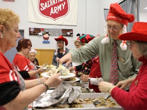 Salvation Army volunteers serve up some of the more than 400 plates of turkey dinners that were dished out to those in need during this year’s annual Salvation Army Christmas Dinner, which was held on Saturday. (Tori Stafford/The Whig-Standard)