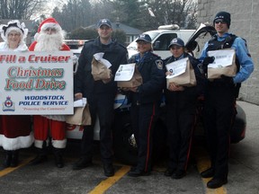 Santa joins members of the Woodstock Police Service at Saturday's Fill-a-Cruiser event at the Sobeys plaza.