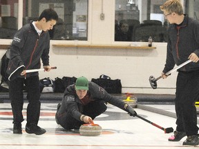 Terry Farrell/daily Herald-Tribune
Daniel Wenzek (left) and Cody Smith get ready to sweep for Daylan Vavrek at a bonspiel earlier this season. Carter Lautner rounds out the rink that will head to Edmonton as the PCA A reps for the junior provincial championships next month.