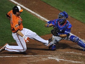 Oriole Taylor Teagarden (L) is tagged out by Blue Jays catcher J.P. Arencibia in Baltimore, Maryland, September 24, 2012. REUTERS/Patrick Smith