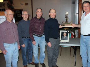SEAN CHASE    Emile Robert (right) presents the Renfrew Curling Club team with the President's Memorial Trophy. Accepting the trophy is (left to right) lead Andy Humphries, second Jim Berg, third Don Rouble and skip Rob Warren.