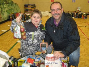 Pierre Gionet, president of Club Richelieu Les Patriotes, and son Samuel, 10, get food bags ready for the service club's annual Christmas drive. CAROL MULLIGAN/THE SUDBURY STAR/QMI AGENCY