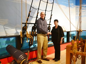 MP for Huron-Bruce Ben Lobb and Cathy McGirr, business manager for the museum shaking hands on the HMS General Hunter boat in thanks to the additional funding.
