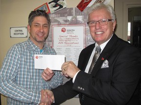 Chatham-Kent Essex MPP Rick Nicholls, right, made a call to action on Monday, Dec. 16, 2012, for other community leaders to do what they can to help the United Way of Chatham-Kent overcome its $300,000 campaign shortfall. Here, he is pictured making a personal donation to Chris McLeod, chair of the Chatham campaign. (ELLWOOD SHREVE, The Chatham Daily News)