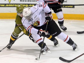 Owen Sound Attack Jaden Lindo, right, tries to muscle past Brampton Battalion Marcus McIvor during first period action at the Lumley Bayshore in Owen Sound on Saturday. James Masters/The Sun Times