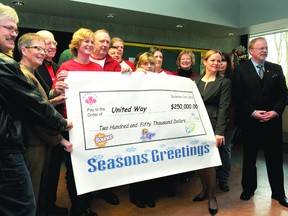 Proctor and Gamble Brockville staff help United Way of Leeds and Grenville executive director Judi Baril, second from left, and United Way president and CEO Sr. Jacline Abray-Nyman support a hefty cheque for $250,000 on Thursday.