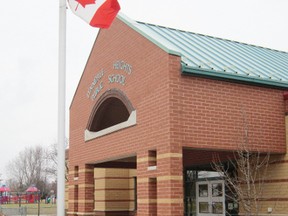 Staff at Lynndale Heights Public School in Simcoe placed a bouquet of flowers at the base of their flag pole as a humble memorial to the children and teachers who were killed in Newtown, Connecticut on Friday. (MONTE SONNENBERG Simcoe Reformer)