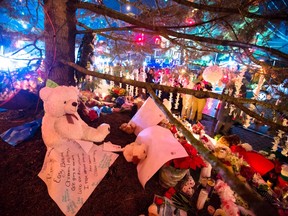 Items left by mourners adorn a large Christmas tree at a memorial to the victims of the recent shooting in Sandy Hook Village in Newtown, Connecticut, December 17, 2012. Authorities continue to investigate the December 14 massacre in Connecticut in which a heavily armed gunman entered Sandy Hook Elementary School in Newtown and shot children and adults resulting in 28 deaths, including the gunman and his mother. 
Reuters/QMI Agency