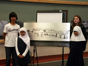 Students from the Fort McMurray Islamic School and Greely Road School, left to right, Carl Esteban, Aanisa Abeer, Elizabeth Barry and Ayesha Khan, present the 1942 to 1952 decade marker at Monday’s December board of trustees meeting for the Fort McMurray Public School District. AMANDA RICHARDSON/TODAY STAFF