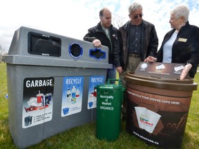 Manager of Environmental Services Chris Collyer , Mayor Francis Richardson and Councillor Lynda Stephens with Municipality of Meaford recycling bins for various drinking containers including coffee cups and organic material in April, 2012. Sun Times file photo