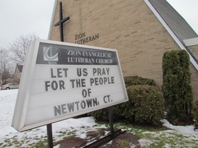 A sign outside Zion Evangelical Lutheran Church, on Wellington Street East,  recognizes residents of Newtown, Conn., where, last Friday, 26 people, including 20 children, were killed at the Sandy Hook Elementary School by a gunman.