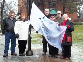 City hall raised a flag in support of the Children’s Christmas Fund. Joining the celebration were Children’s Christmas Fund representatives Terry Muir, Theresa Taylor, Peter Morgan, Marvin Plumadare and Lee Cassidy, along with Mayor Bob Kilger (centre).
Staff photo/KATHRYN BURNHAM