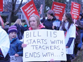 Local members of the Elementary Teachers Federation of Ontario and their supporters mounted a large picket line in front of Waterford District High School Tuesday morning. Parent Alexandria Barber, of Waterford, brought along her daughter Maya, 9, as well as her own sign.  (MONTE SONNENBERG Simcoe Reformer)