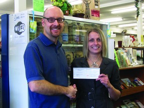 Portage MCC manager Kevin Hamm presents a cheque to Erin Miller-Simpson, executive director of the Portage Hospital Foundation. The funds were raised by the day of charity held by the store on Nov. 20. (ROBIN DUDGEON/PORTAGE DAILY GRAPHIC/QMI AGENCY)