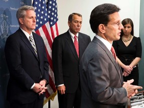 U.S. House Speaker John Boehner (C)(R-OH) and House Majority Whip Kevin McCarthy (L)(R-CA) watch as House Majority Leader Rep. Eric Cantor (R-VA) speaks during a news conference after a Republican caucus meeting on Capitol Hill in Washington on December 18, 2012.  REUTERS/Joshua Roberts