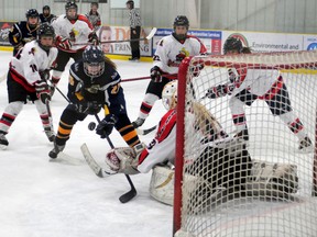 Terry Farrell/Daily Herald-Tribune
Storm forward Corbin Welsh is poke-checked at the last moment by Lloydminster goalie Kayla Robinson. The Grande Prairie Storm defeated the Lloydminster Steelers 4-1 in Alberta Major Midget Female Hockey League play at the Dave Barr Arena in Grande Prairie Saturday.