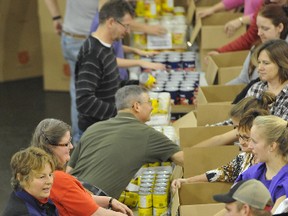 Over 100 volunteers pack Christmas Hampers for the Salvation Army at the Princess of Wales Own Regiment on Montreal Street on Tuesday. For a video of the hamper packing go to thewhig.com and click on the on-line story.
Jeff Peters for The Whig-Standard