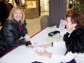 Peggy Haramis, campaign chair for the United Way, sells tickets to Darlene Filion for the Christmas sleigh raffle. The draw will be held at the Cornwall Square on Friday starting at 11:30 a.m. 
Staff photo/ERIKA GLASBERG